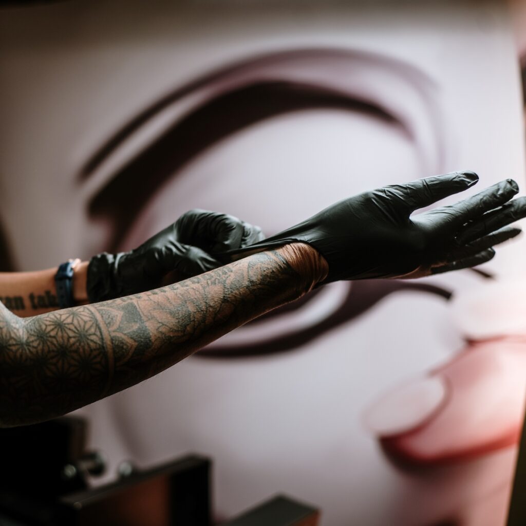 Tattoo artists putting gloves on